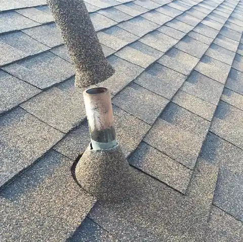 Stone coated sleeve sliding down over an existing pipe