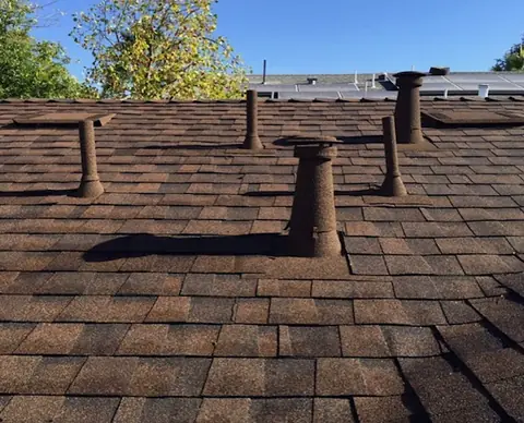 Brown stone coated vents and sleeves on brown shingles