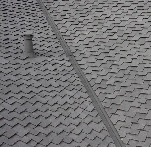 Grey stone coated valley and a small pipe on grey shingles