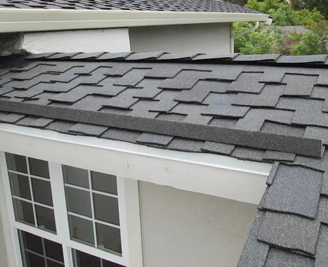Stone coated edge metal along a grey roof above a window