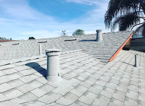 Light grey stone coated vents on a light grey roof