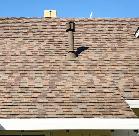 Brown stone coated pipe on brown shingles