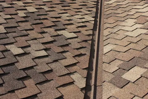 Stone coated valley metal on a brown blend shingle roof